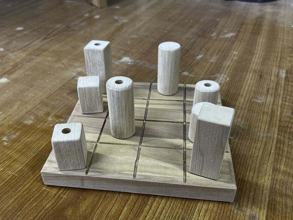 Starting to take shape Some game pieces on the game board before sanding and finishing