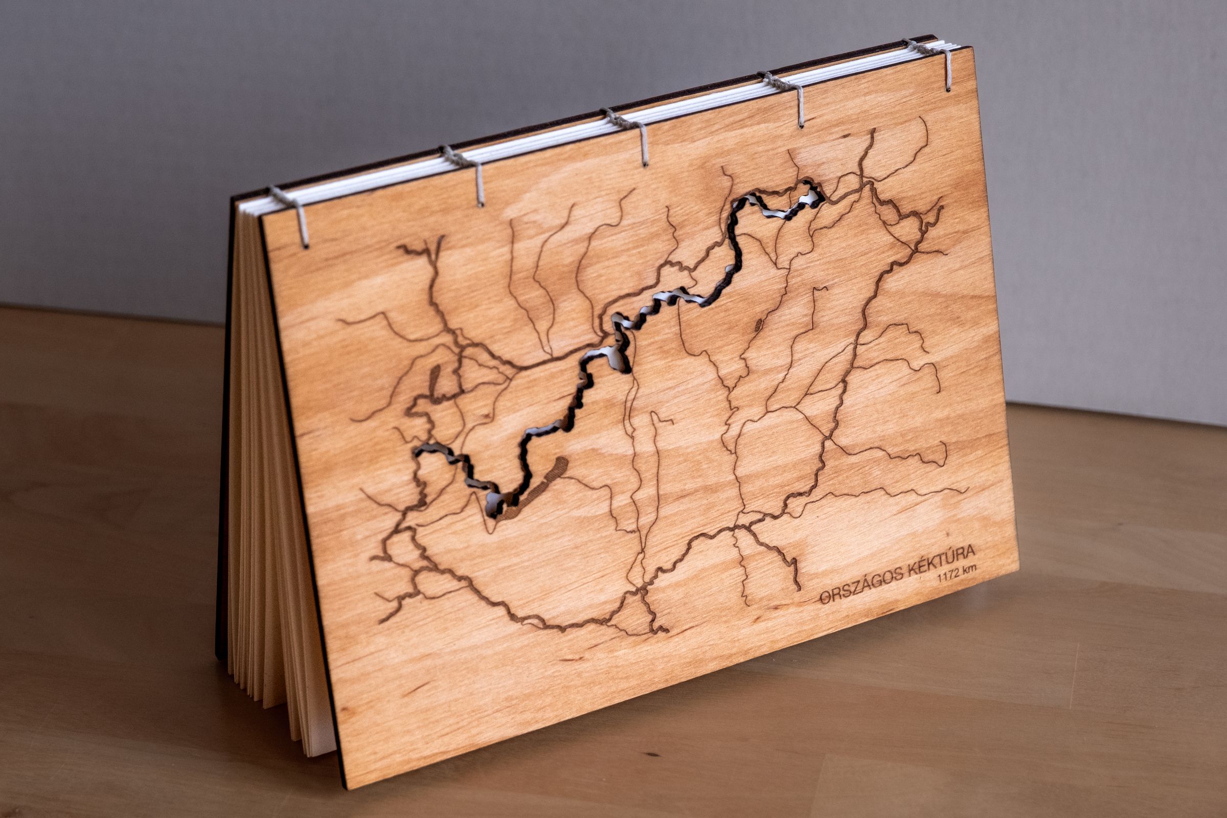 A custom photo album with laser-engraved wooden covers